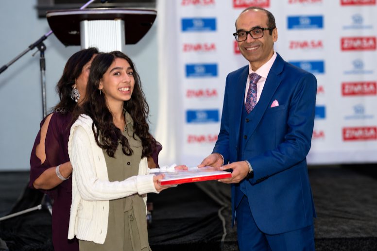 Bharat Batra presenting a gift at a Mortgage Diligent event